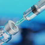 Medical disposable syringe for vaccine injection and glass vial.