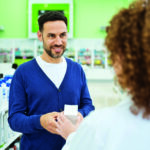 Male customer talking with pharmacist
